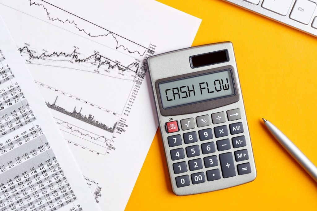 Calculator and financial documents on yellow background, symbolizing tax season and offering tips